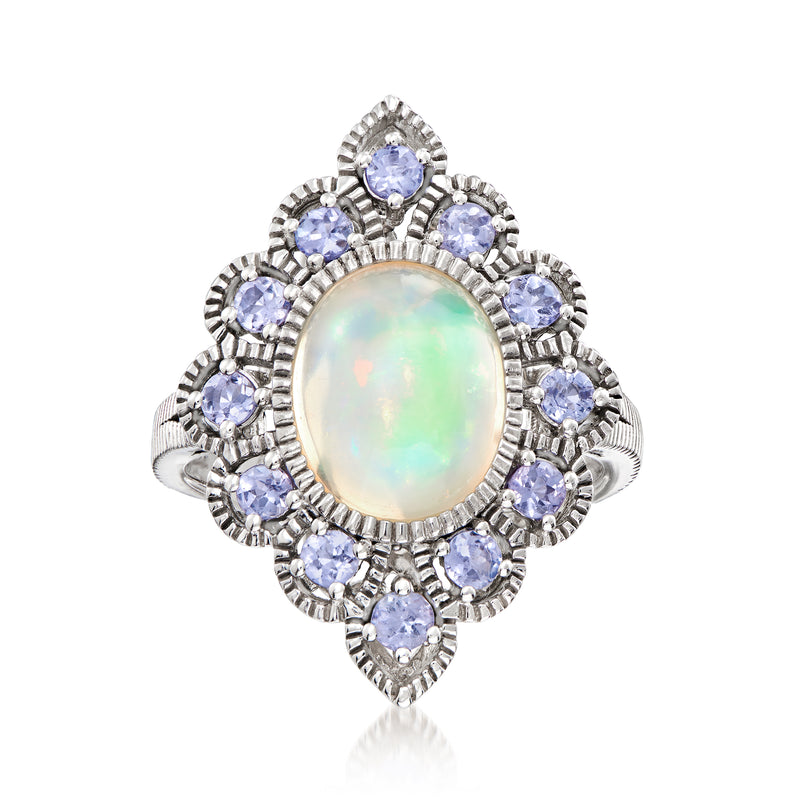 Sterling silver ring with oval opal center and blue Tanzanite-style stone halo