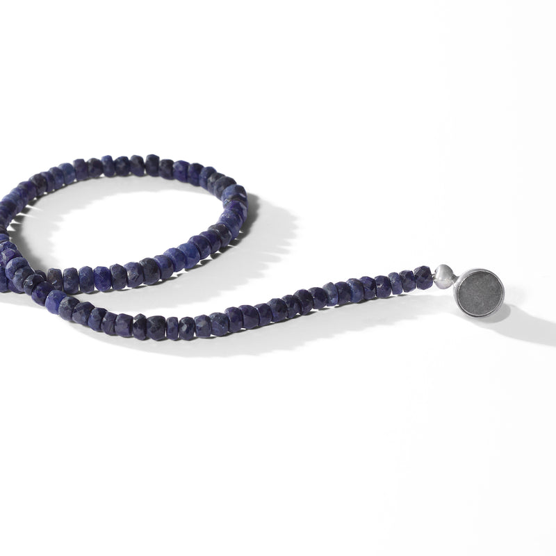 Sapphire blue bead necklace laid flat with sterling silver clasp detail.