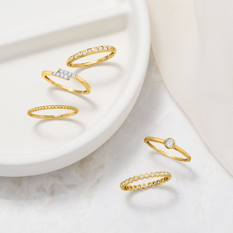 Yellow gold diamond eternity band with bezel-set stones, shown upright