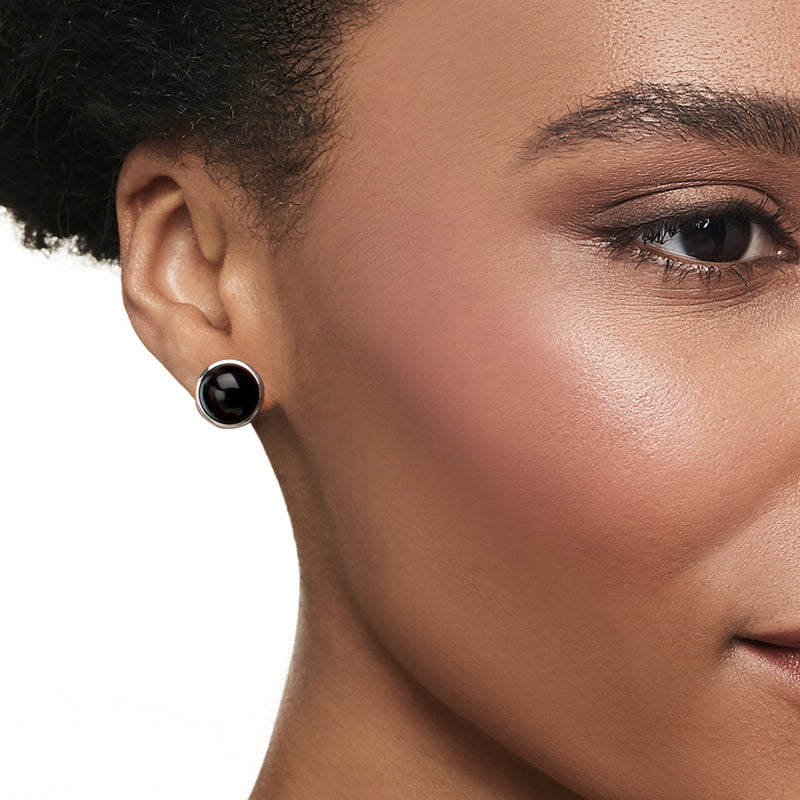 Single round black onyx stud earring with sterling silver backing on ear