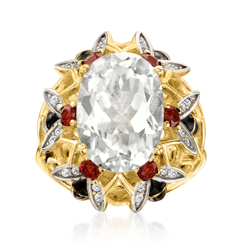 18kt gold over sterling ring with oval clear center stone, red garnets, and white accents