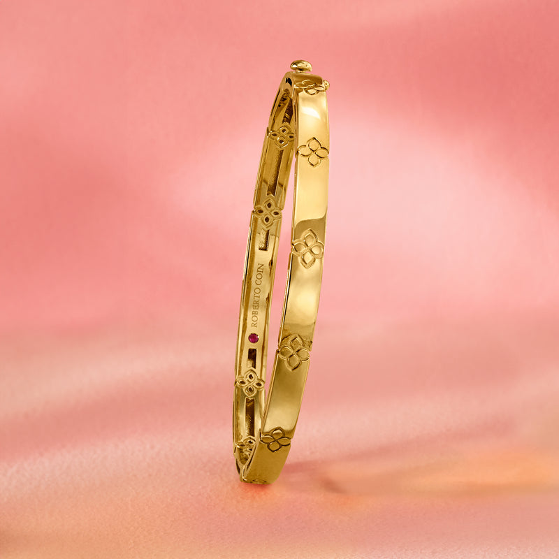 18kt yellow gold bangle bracelet with floral cutout pattern, slim profile