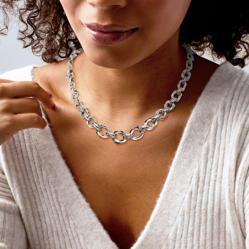 Sterling silver oval-link necklace on model's neck, graduated polished chain links