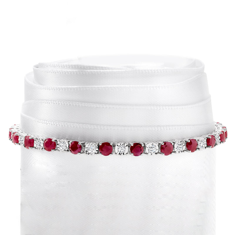 Sterling silver tennis bracelet with bezel-set oval pink rubies and diamond accents