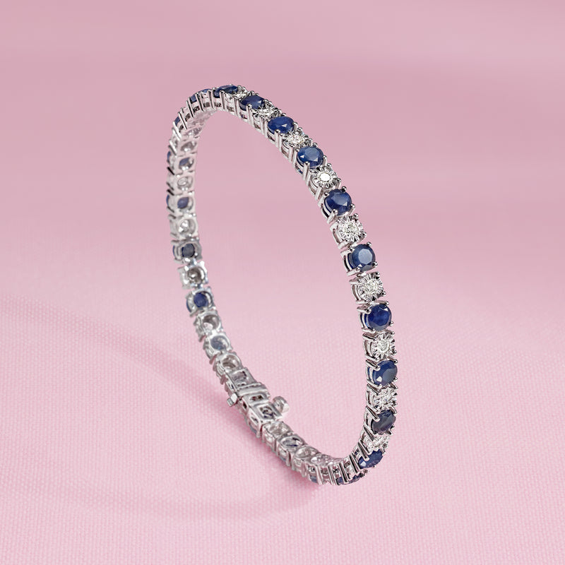 Sterling silver tennis bracelet with blue sapphire stones and diamond accents