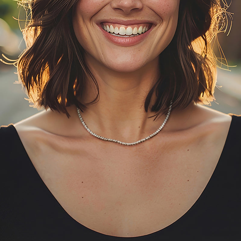 Sterling silver diamond tennis necklace worn at collarbone on model.