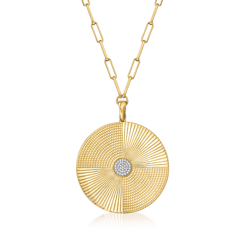 Gold medallion pendant necklace with round sunburst design and small central diamond.