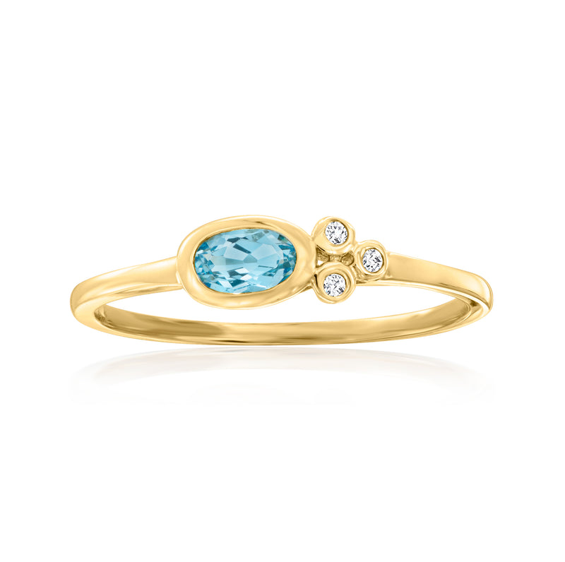 14kt yellow gold ring with oval sky blue topaz center and four round diamond accents