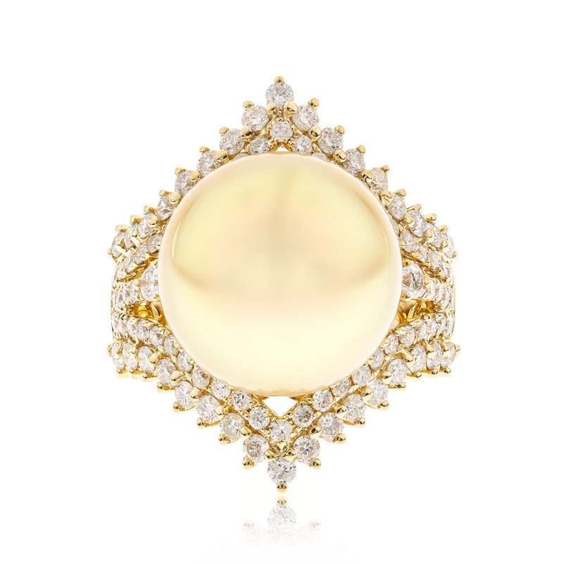 Yellow gold ring with round pale yellow pearl center and diamond halo, prong-set.