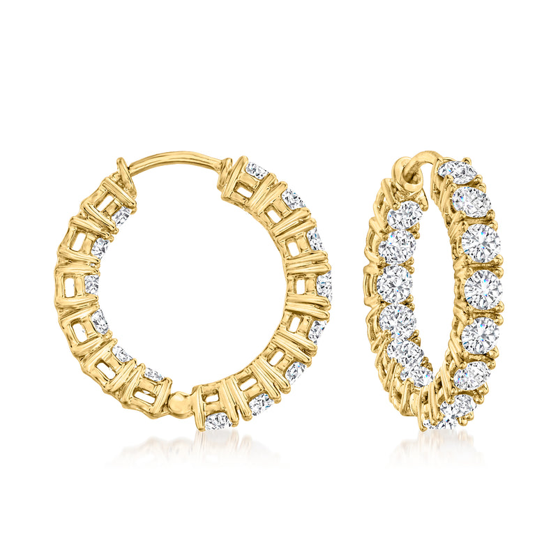 Gold hoop earrings with inside-out diamond-look stones and baguette accents
