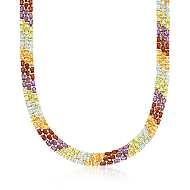 Multi-gemstone tennis necklace with round red, purple, green, and blue stones in gold-tone setting