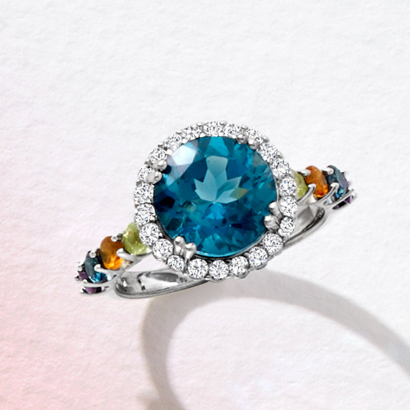 Sterling silver ring with oval London blue topaz and diamond halo, green yellow blue accents