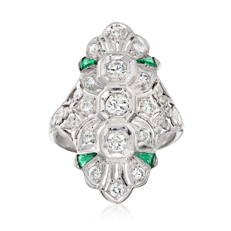 Vintage platinum filigree ring with round diamonds and green emerald accents