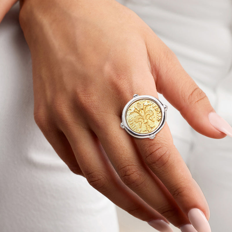 Coin-style two-tone sterling silver ring with gold medallion worn on hand