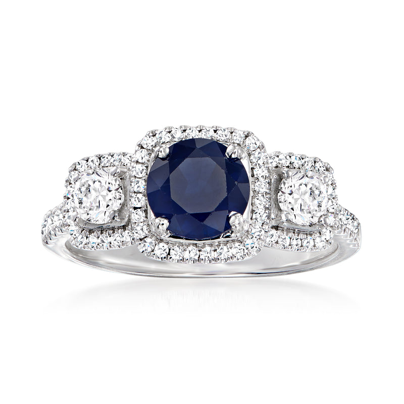 White gold halo ring with dark blue cushion sapphire and diamond accents