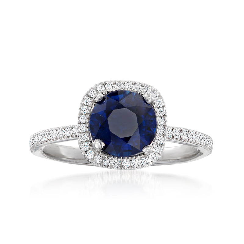 White gold diamond halo ring with round blue center stone