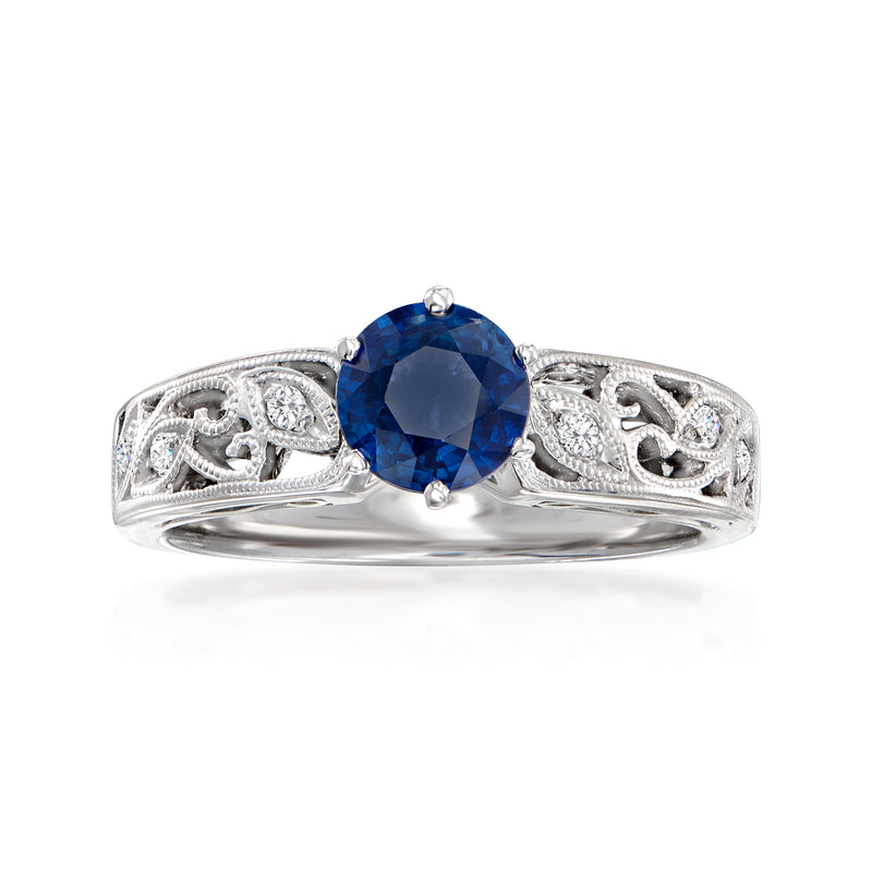 18kt white gold ring with oval blue sapphire center and diamond accents in ornate setting