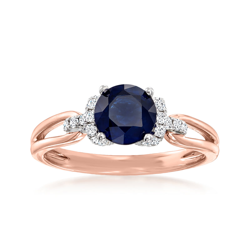 Two-tone gold ring with oval dark-blue sapphire and four round diamond accents