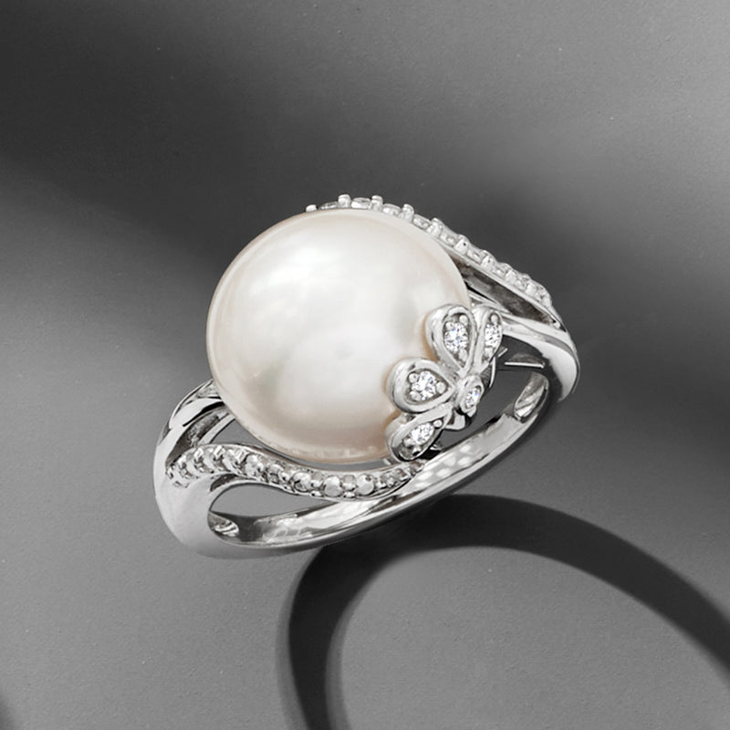 Sterling silver ring with white cultured pearl, diamond halo details, and twisted band