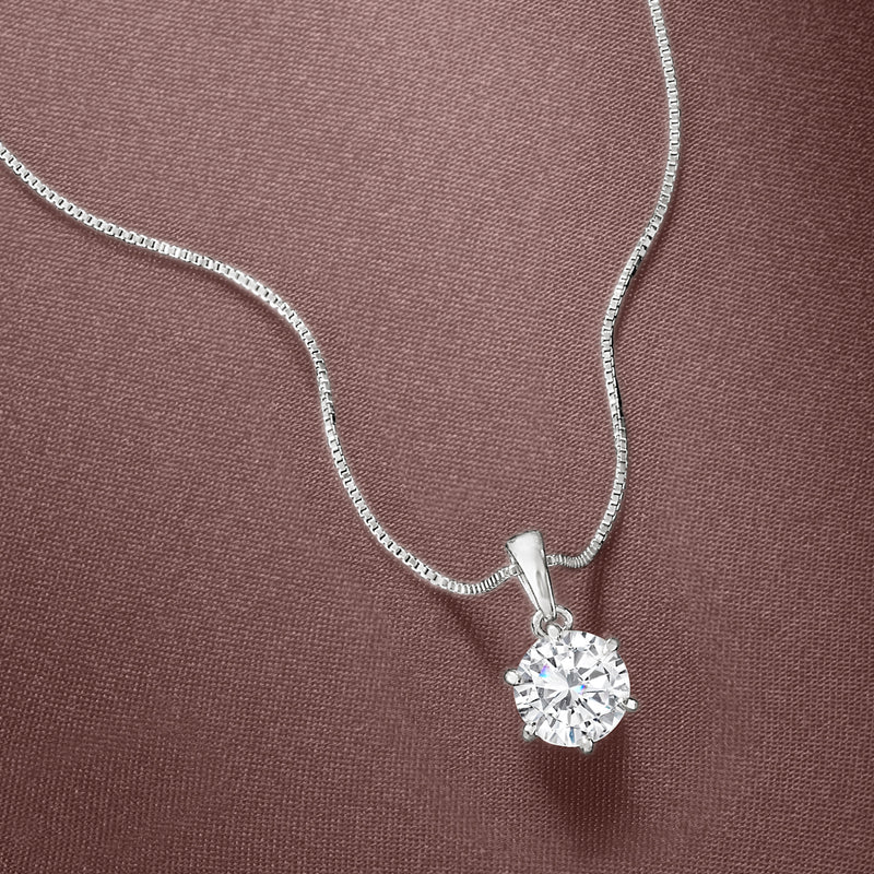 Close-up sterling silver solitaire necklace with round moissanite pendant