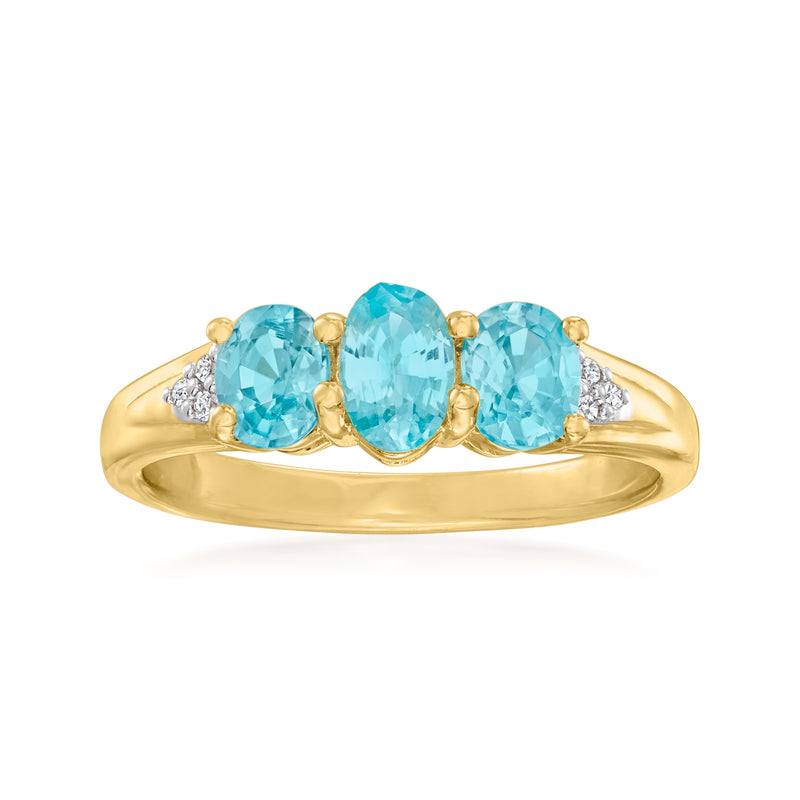 Gold-tone three-stone ring with three oval blue zircon and small white zircon side accents