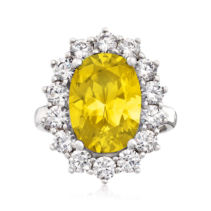 Oval simulated yellow gemstone halo ring in sterling silver with clear round stones
