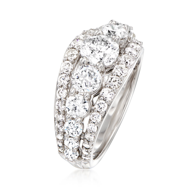 White gold diamond multi-row ring with a large center round stone and side clusters.