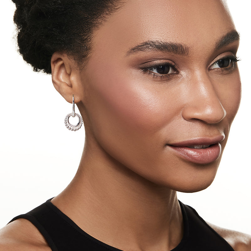 Sterling silver double-circle hoop earrings with bead halo on model