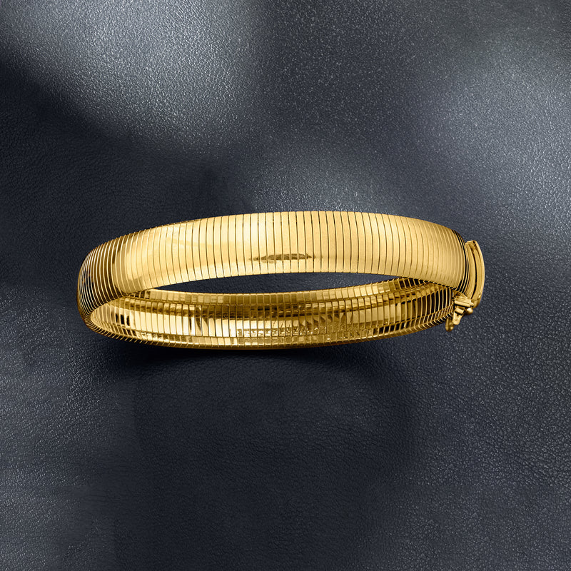 Omega bracelet in 18kt gold over sterling with ribbed mesh links and gold clasp