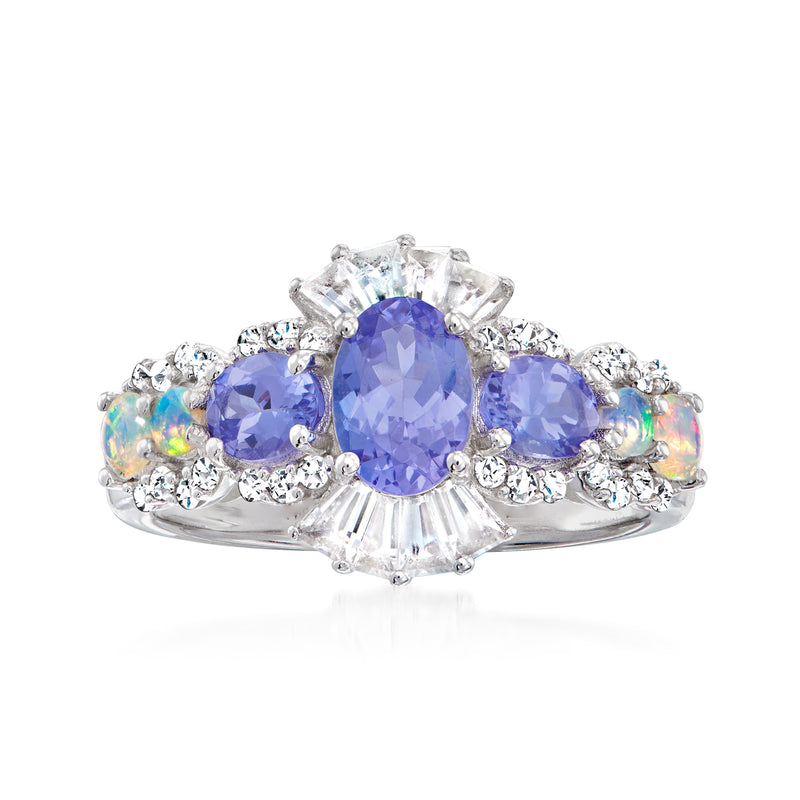 Sterling silver ring with three blue gemstones, opal accents, and small clear stone halo
