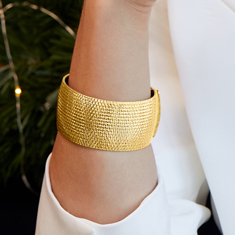18kt gold over sterling mesh omega bracelet worn on wrist, wide smooth band