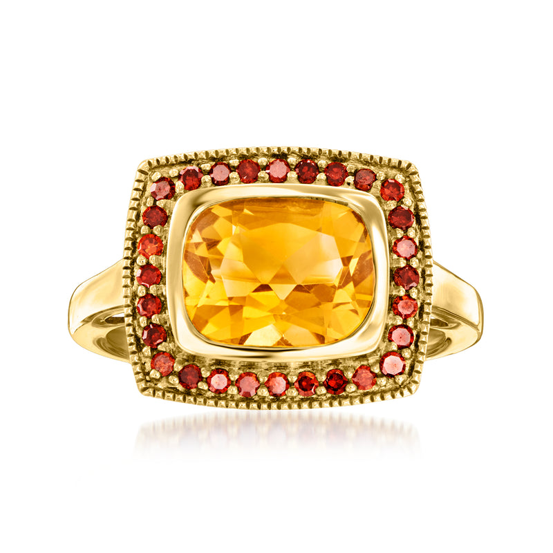 Gold-tone ring with large rectangular citrine centerpiece and red gemstone halo