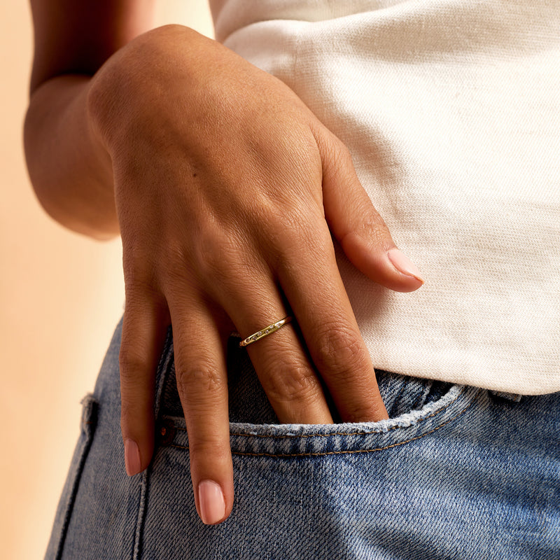 14kt yellow gold diamond dotted ring on finger with round stones