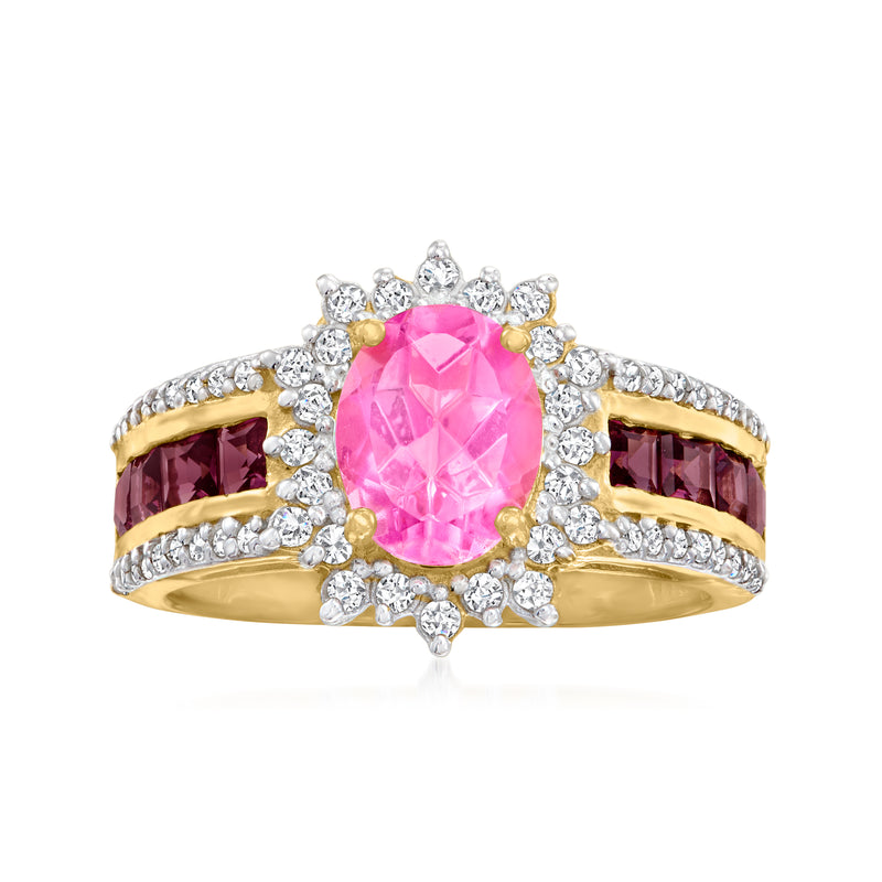 Pink oval topaz-style center ring with white zircon halo, gold setting, dark side stones