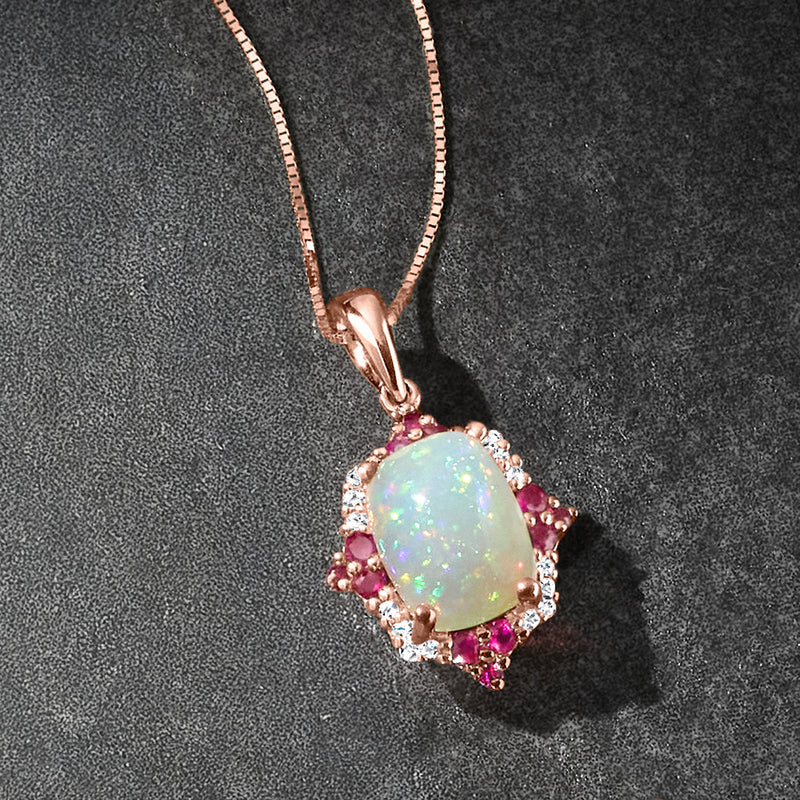Rose gold oval opal pendant necklace with ruby side stones and diamond border