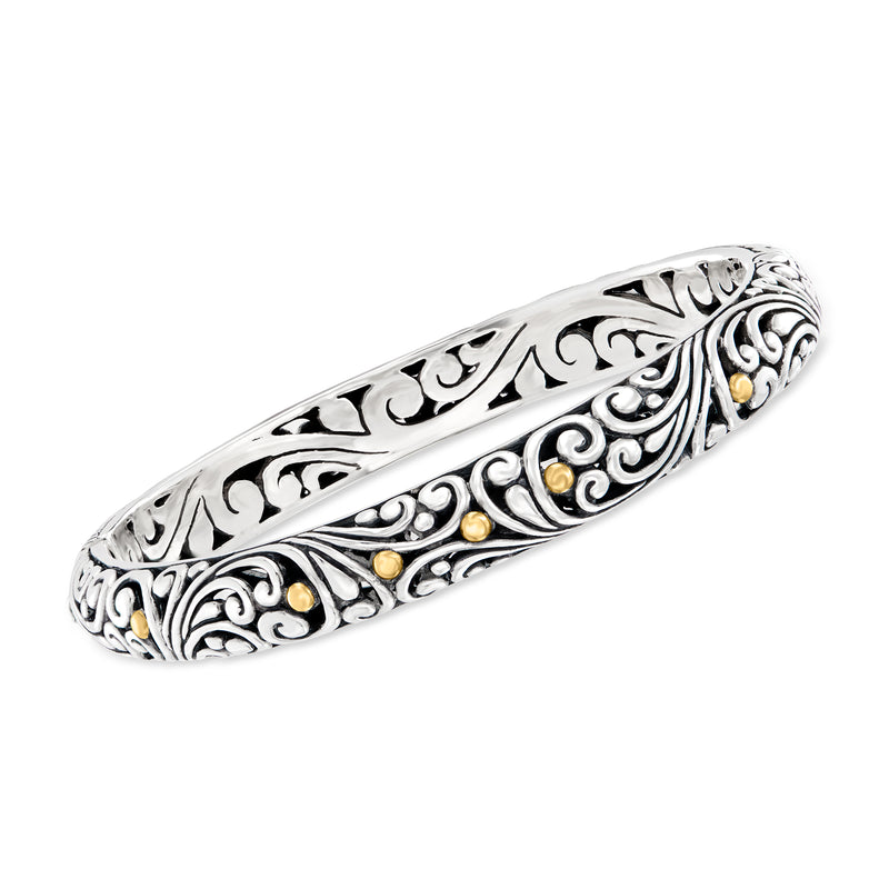 Sterling silver bangle with ornate scrollwork and small 18kt yellow gold accents
