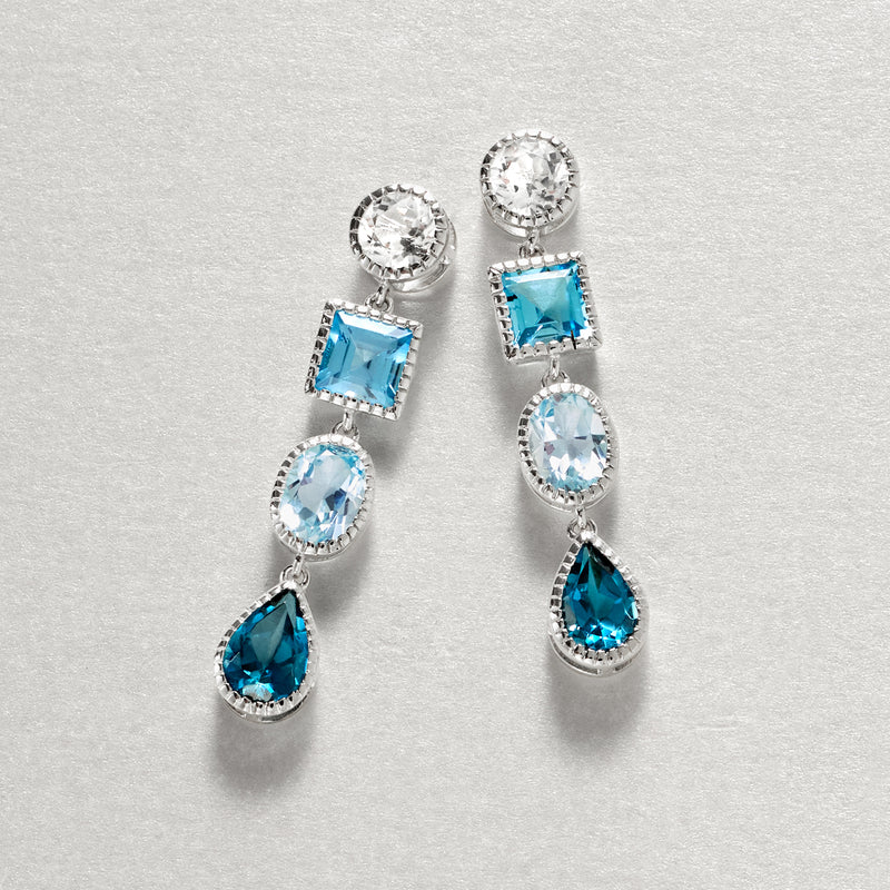 Sterling silver drop earrings featuring blue topaz stones and round white accents