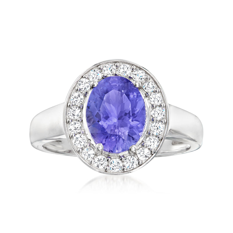 Oval tanzanite halo ring in 14kt white gold with round diamond accents and split shank