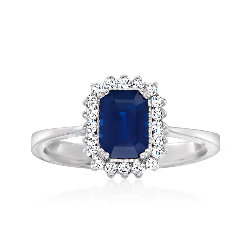14kt white gold ring with rectangular dark blue sapphire center and diamond halo