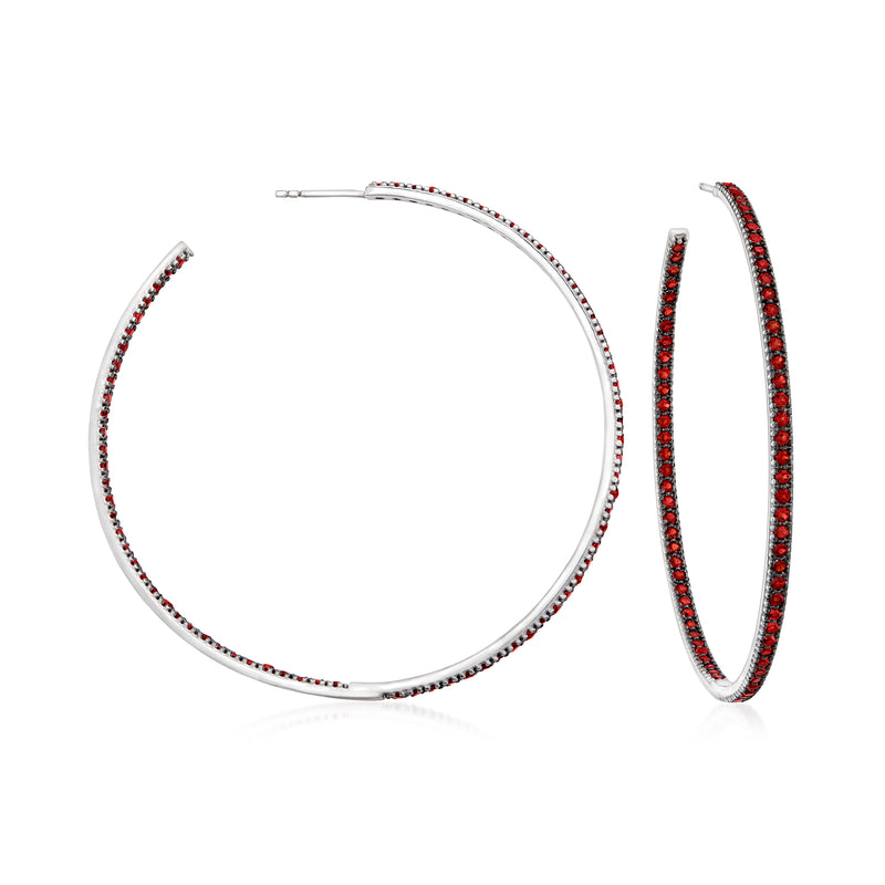 Sterling silver hoop earrings with red garnet-like stones, polished loop design