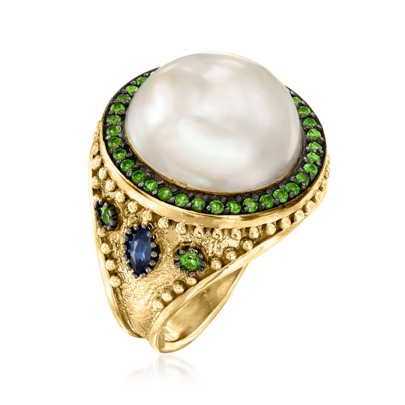 Gold mabe pearl ring with green halo, blue accent stone, and scalloped edge