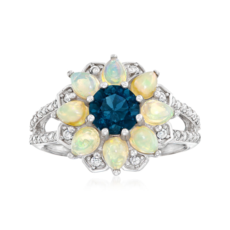 Sterling silver flower ring with oval London blue topaz center and opal-like white petals