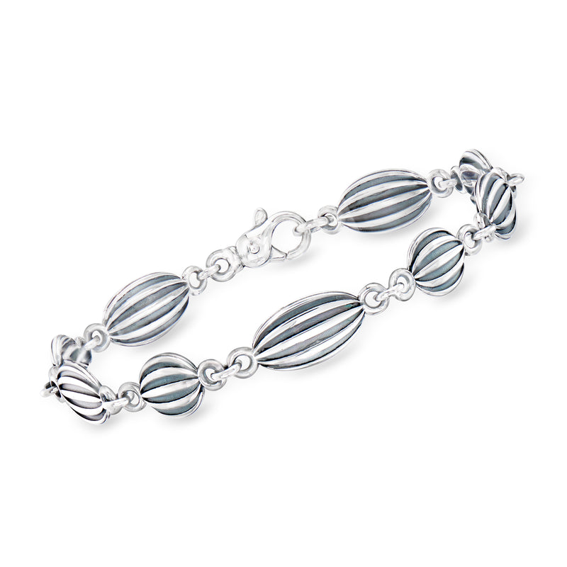 Sterling silver bracelet with ribbed beachball-style blue enamel oval links
