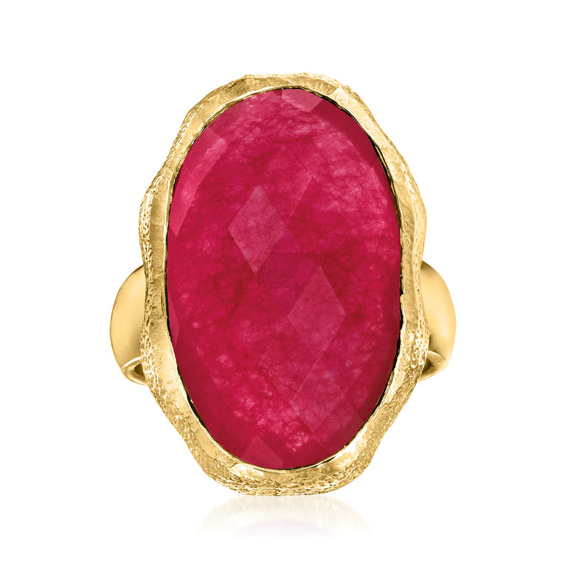Gold-tone oval pink gemstone ring with textured bezel and split shoulders