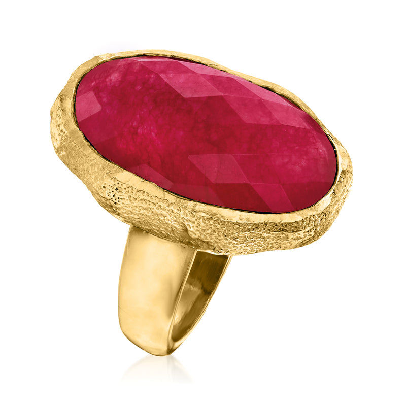 Gold-tone oval pink gemstone ring with textured band and raised oval setting