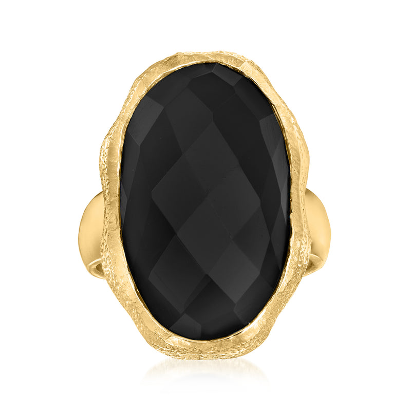 Gold-tone oval onyx ring with faceted black gemstone and hammered bezel