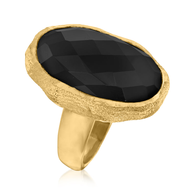Gold-tone oval onyx statement ring with faceted black gemstone and open band
