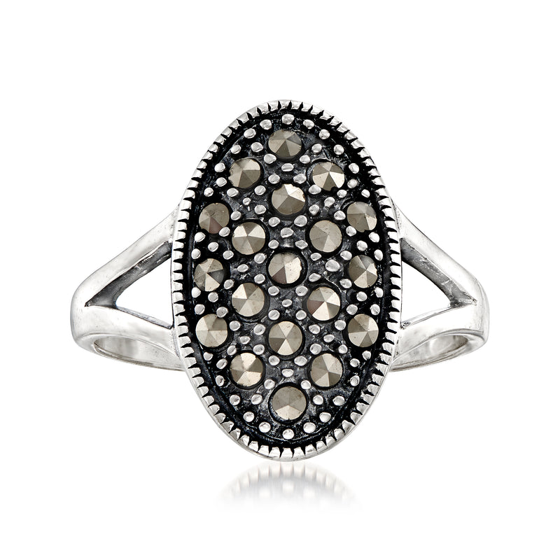 Oval sterling silver ring with black marcasite-style gemstone halo and scalloped edge