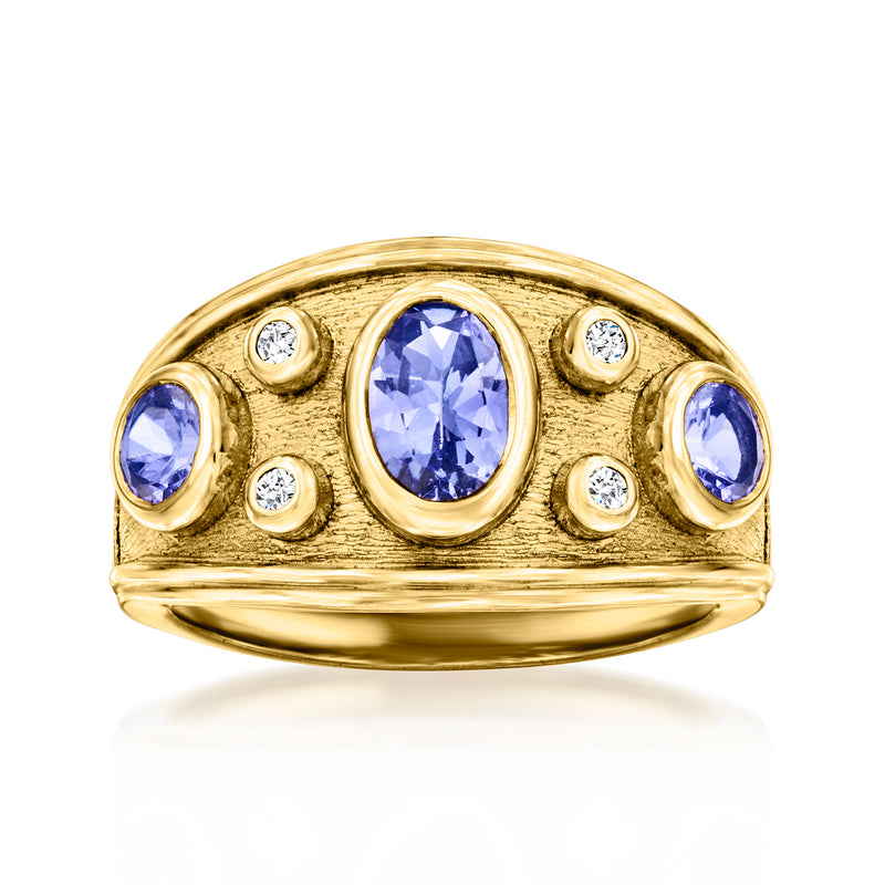 Gold ring with raised oval tanzanite center stone, small round clear stones, and blue accents
