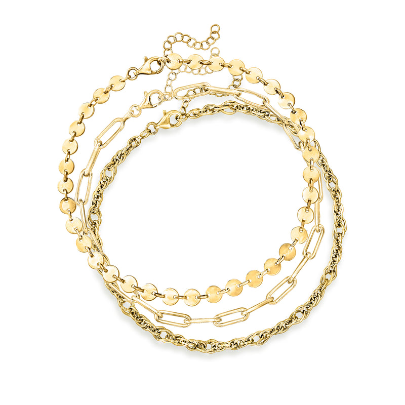 Three gold-tone anklets set with mixed chain links and small charm accents